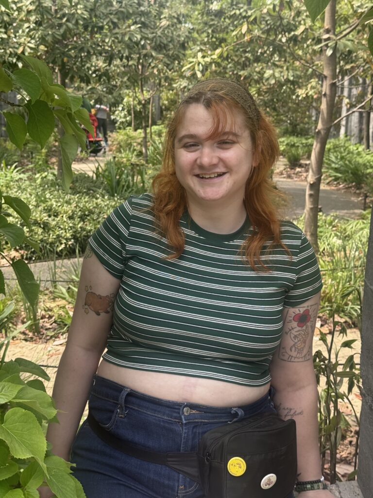 Picture of Sierra Lynn sitting in front of a greenery landscape at a local New York City Garden
